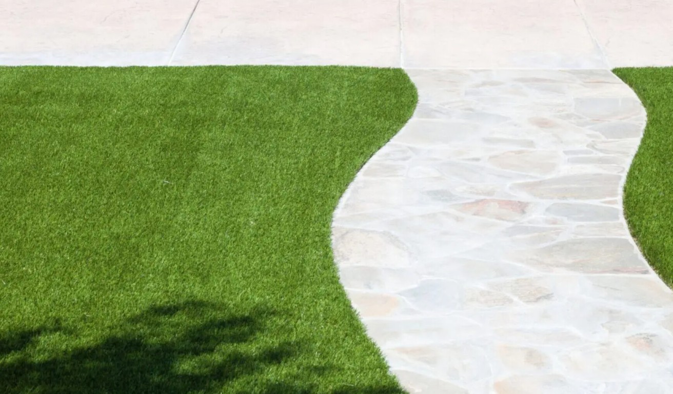 Eco-friendly artificial grass installation alongside paver walkway in Kennewick, WA